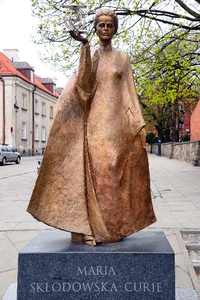 Statue of Marie Skłodowska-Curie by Bronislaw Krzysztof holding a model of Polonium in Warsaw, Poland